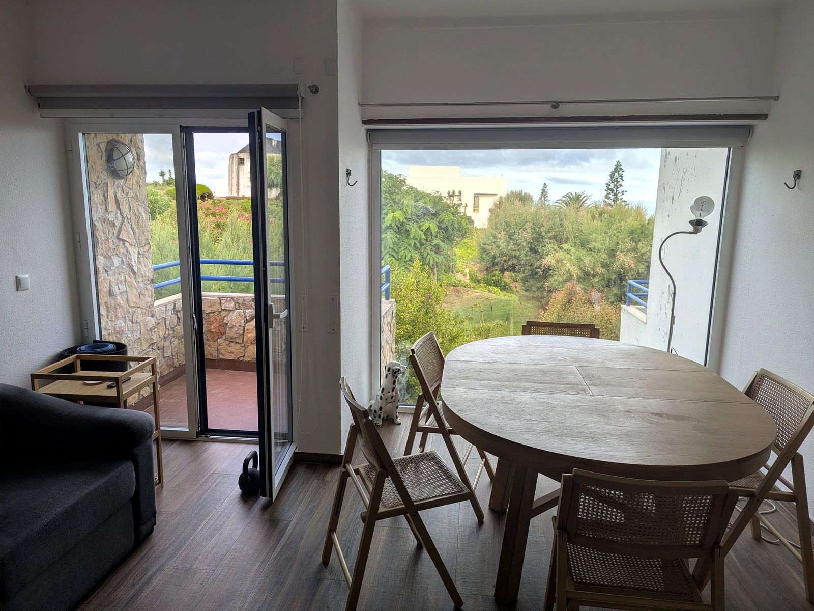The same room in daylight, with the balcony door open.